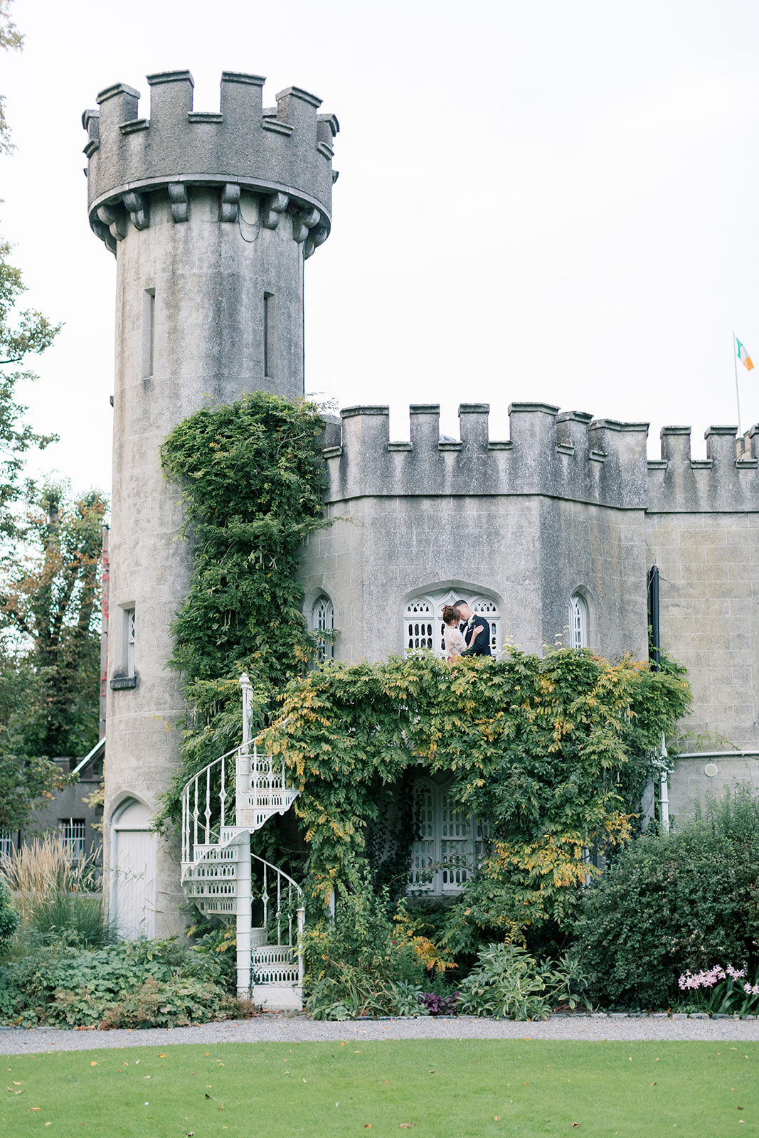 couple's wedding portraits climbing the tower of luttrellstown castle in dublin ireland