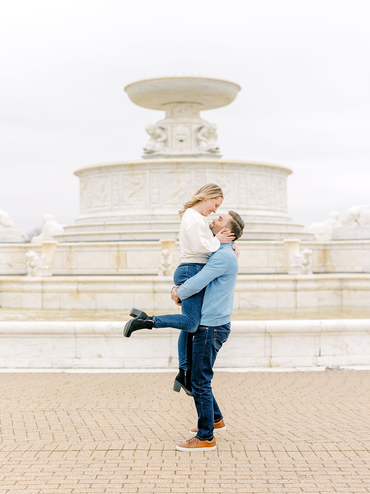 Couple by the fountain at their fall Belle Isle Detroit engagement photography session.