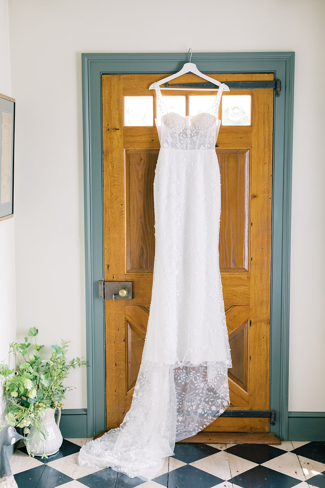 bride's dress hanging in door at historic connecticut wedding venue smith farm gardens