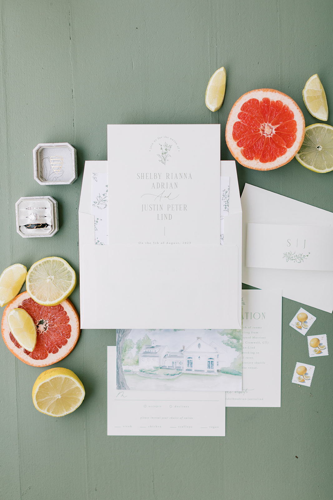 wedding invitation styled with green background and citrus