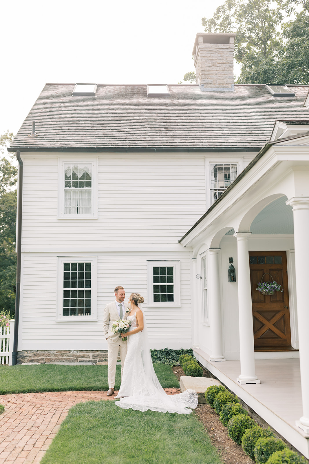 couple's portrait in the front of house at smith farm gardens wedding