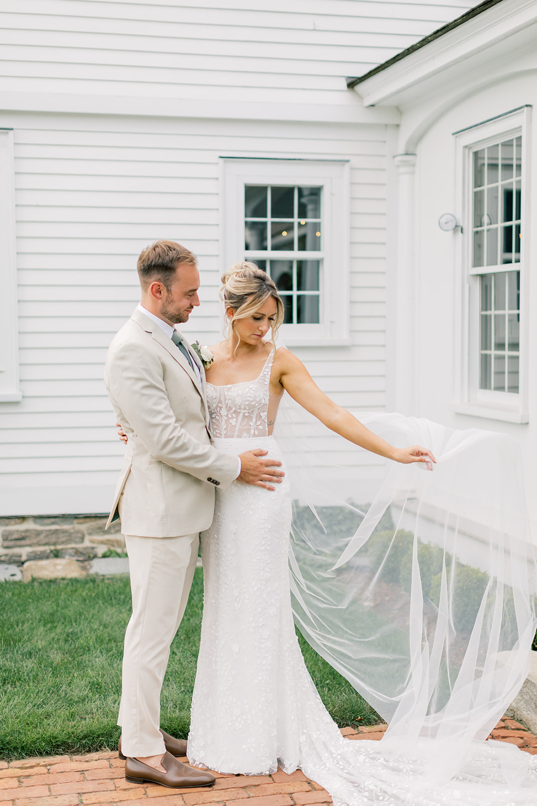 couple's portrait in the front of house at smith farm gardens wedding with veil