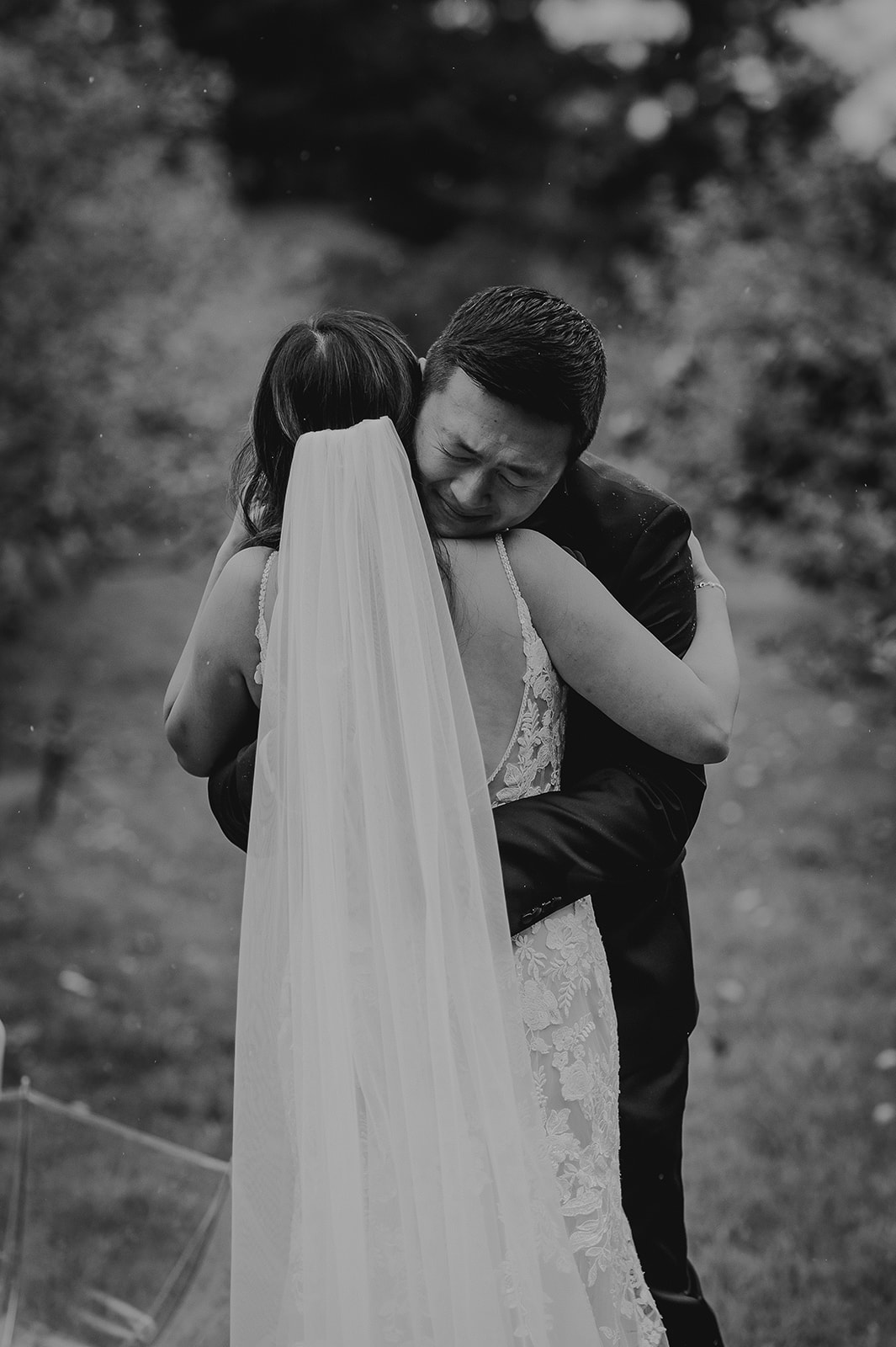 a grooms hugs his bride and cries 