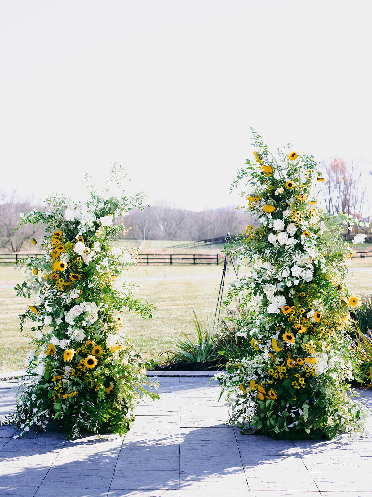 sunflower asymmetrical floral wedding arch at the Middleburg barn wedding 