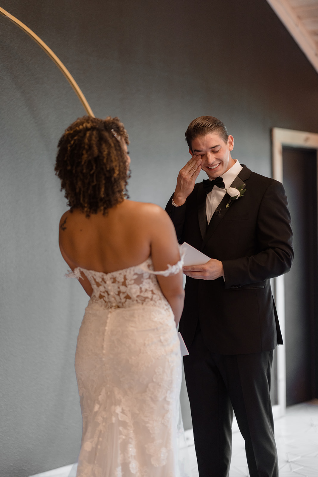 A groom crying at his first look with his bride