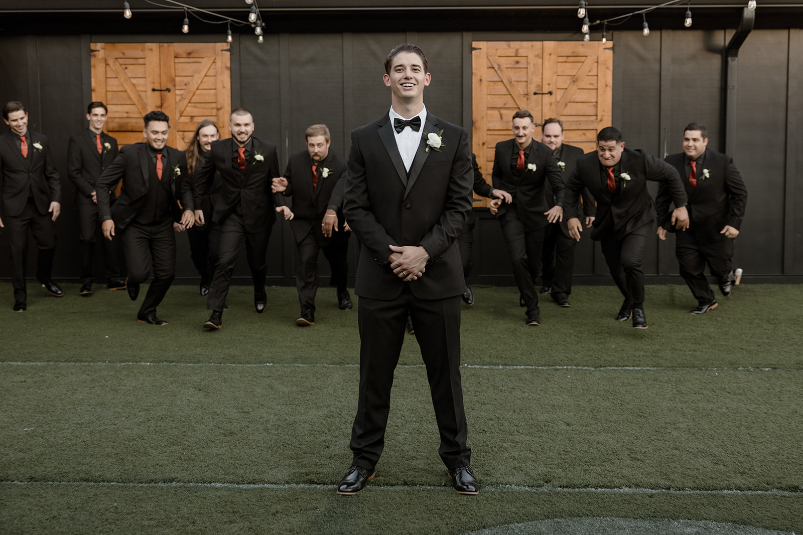 Groom and his groomsmen in classic black suits