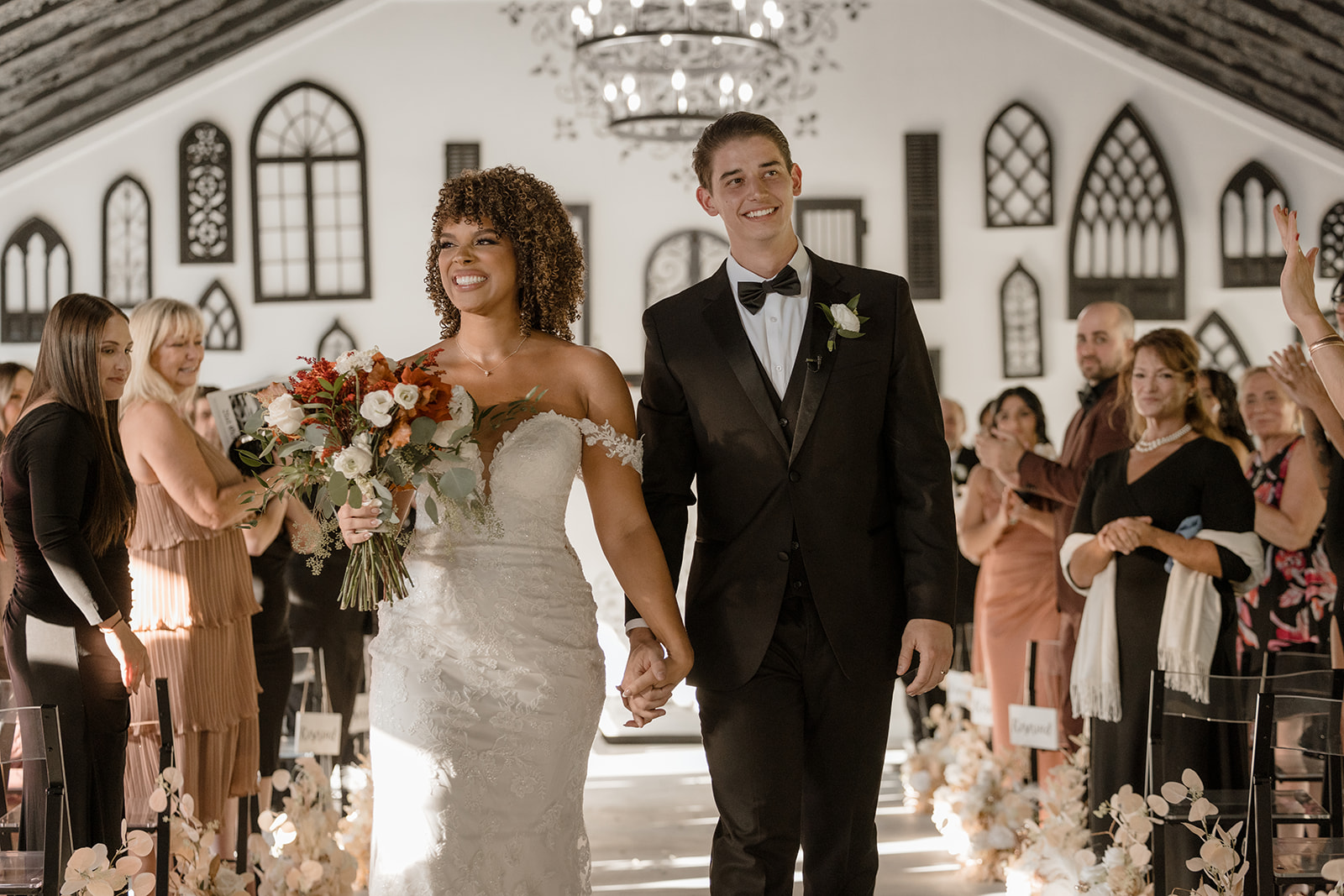 Newlyweds celebrating at their wedding ceremony in Florida wedding venue