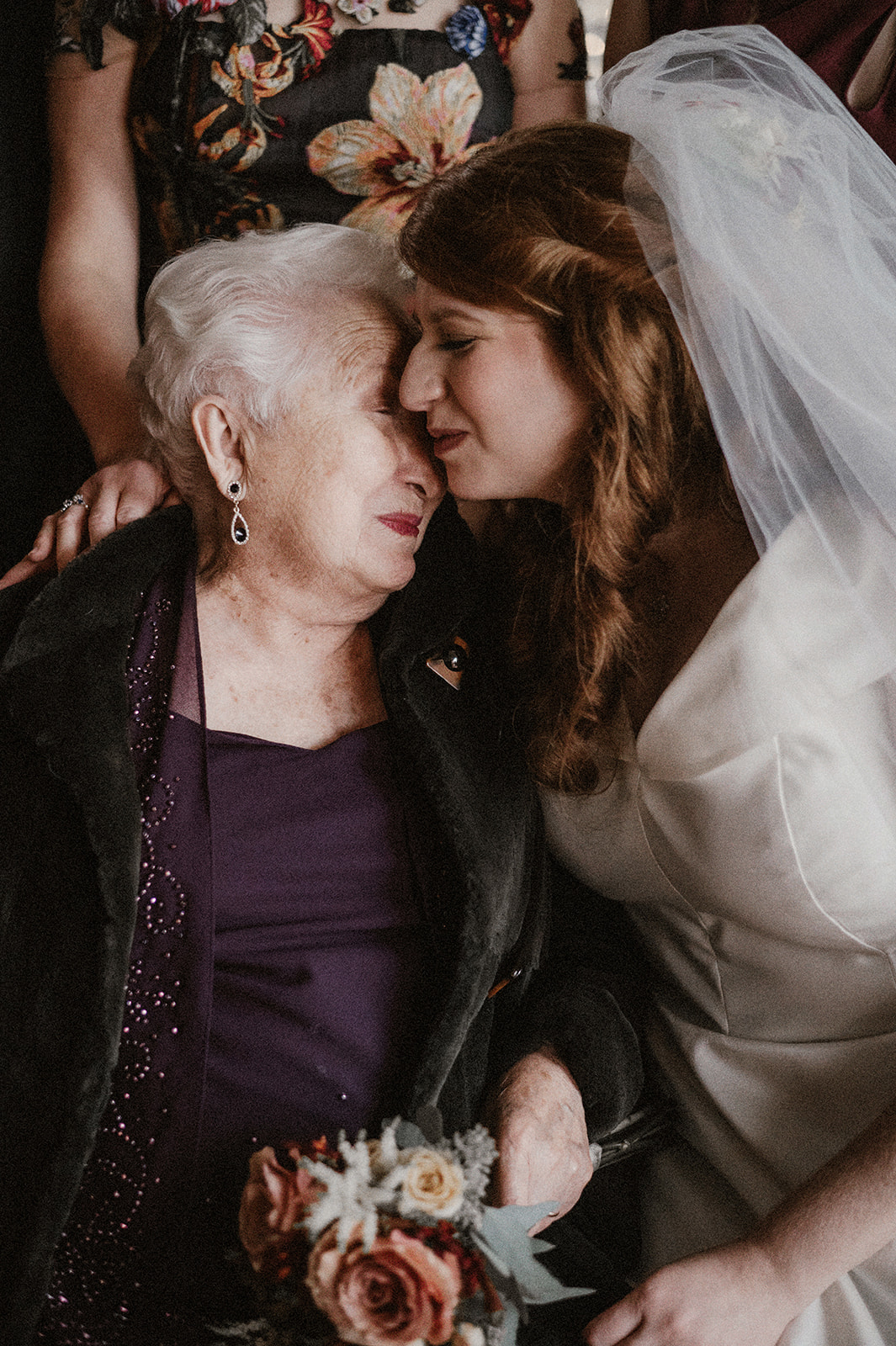 tender moment between bride and grandmother during jewish wedding