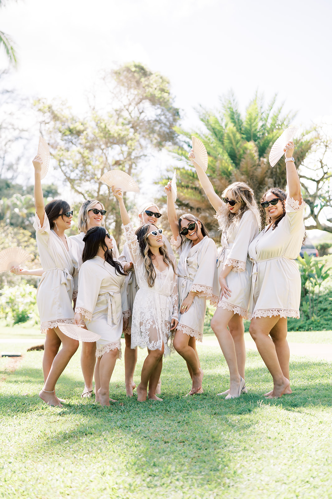 A group of women dressed in white celebrating joyfully outdoors captured by Megan Moura Wedding Photographer