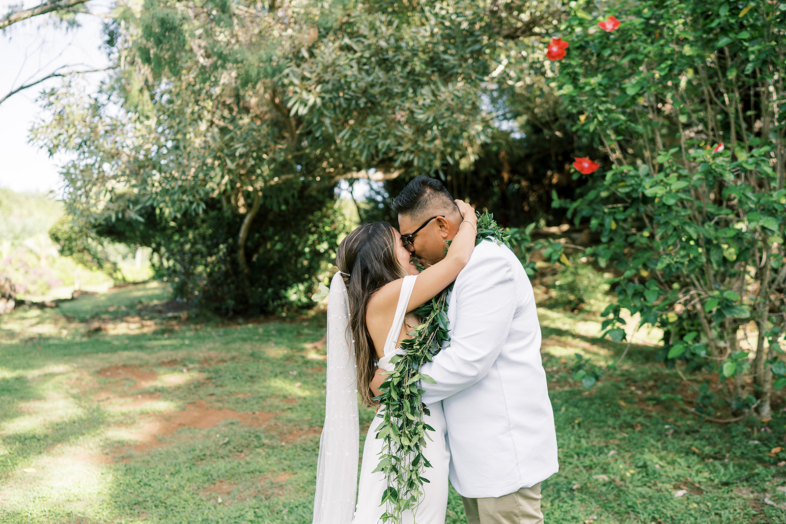 A couple embracing in nature, surrounded by greenery, captured by Megan Moura Wedding Photographer