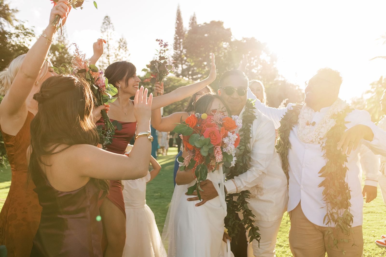 Wedding celebration with joyful guests throwing flower petals on the newlywed couple Hawaiian Wedding in Kauai