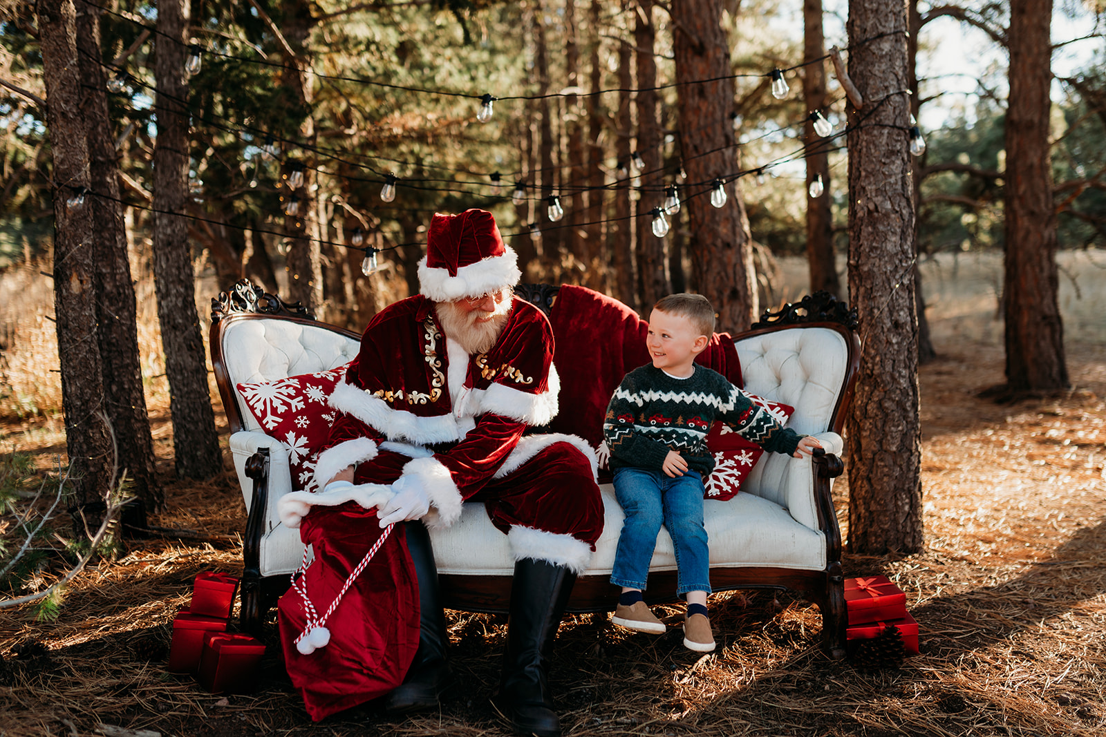 Cozy Woodland Portraits: Santa, Boy, and Girl on a White Couch in Monument, CO