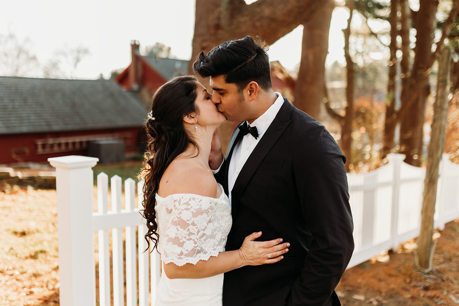 Romantic kiss between the newlyweds against the backdrop of a charming Connecticut home