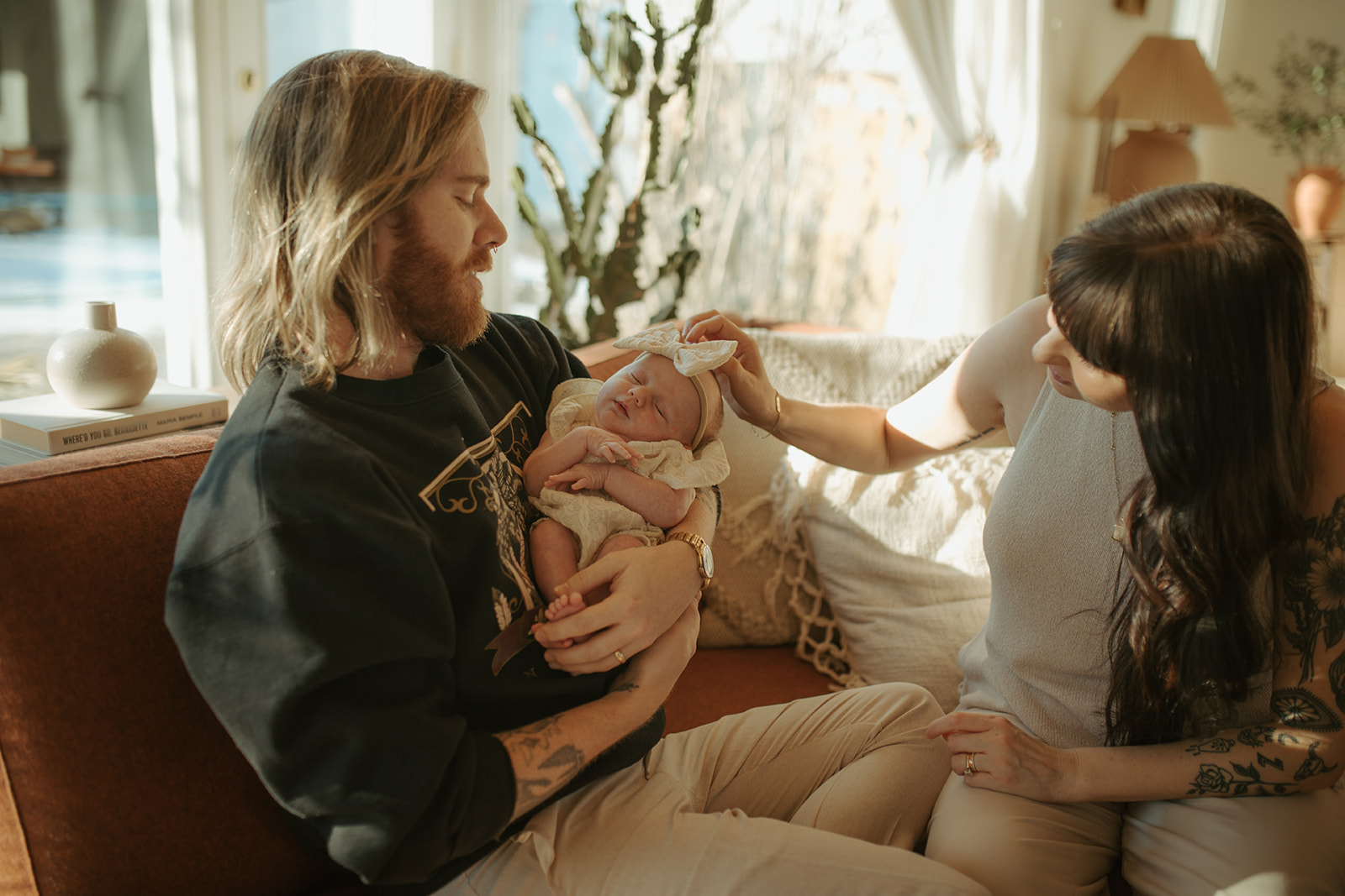 mother and father holding newborn baby in their retro home in Winnipeg, Manitoba
