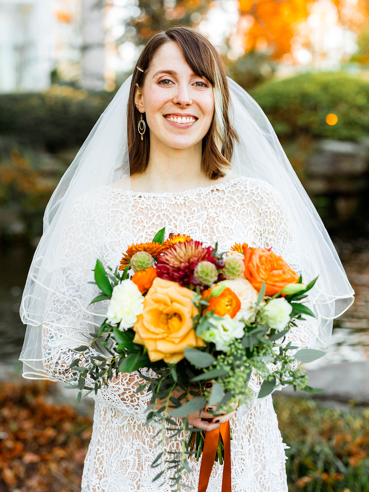 bride smiling with veil holding bouquet in Virginia 