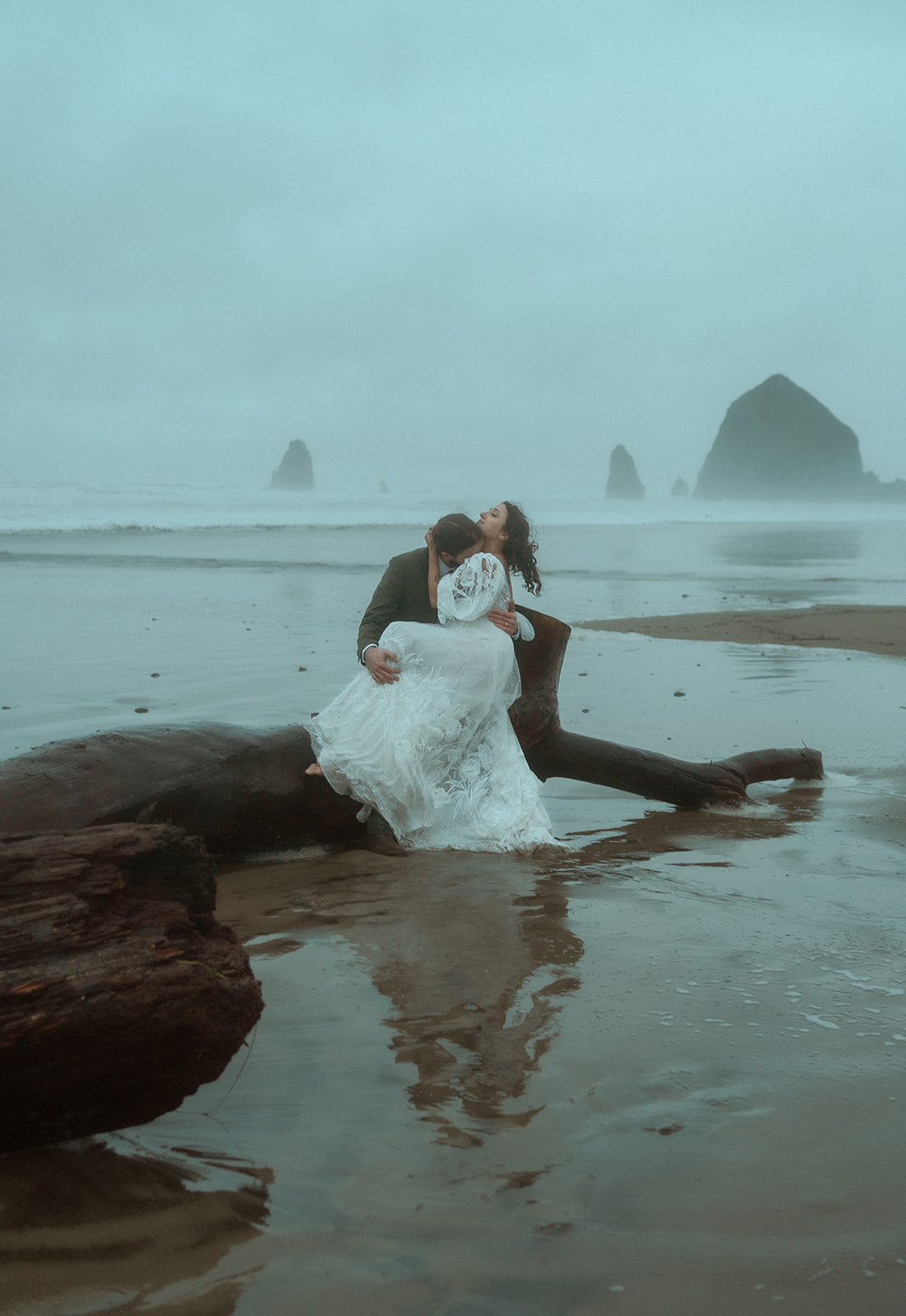 Cannon Beach elopement near Seaside, Oregon in the PNW with vintage long-sleeve dress and Haystack rock with fog