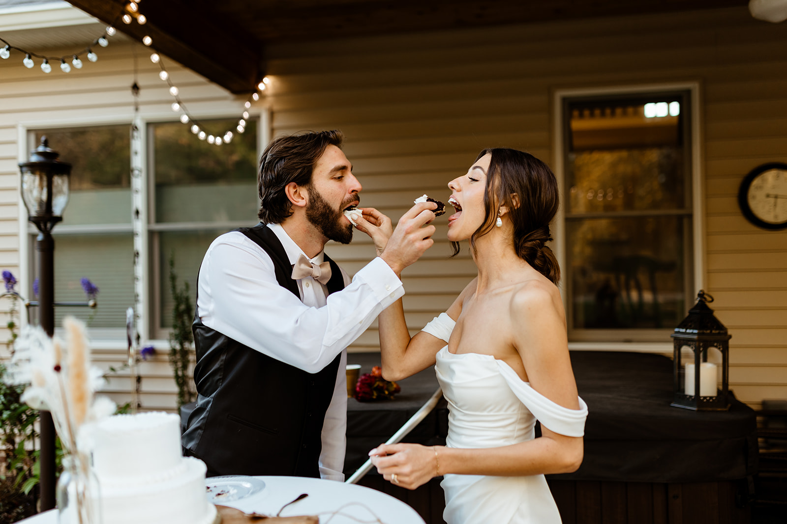 A bride and groom exchange bites of cake at their wedding reception in Arlington, Virginia. 