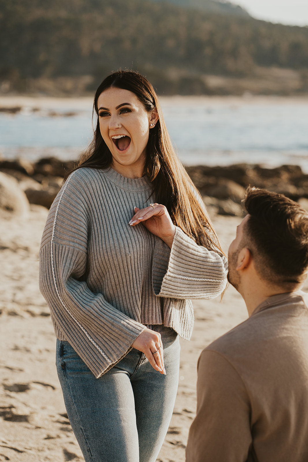 Overjoyed after being proposed to on the beach in Carmel-by-the-Sea