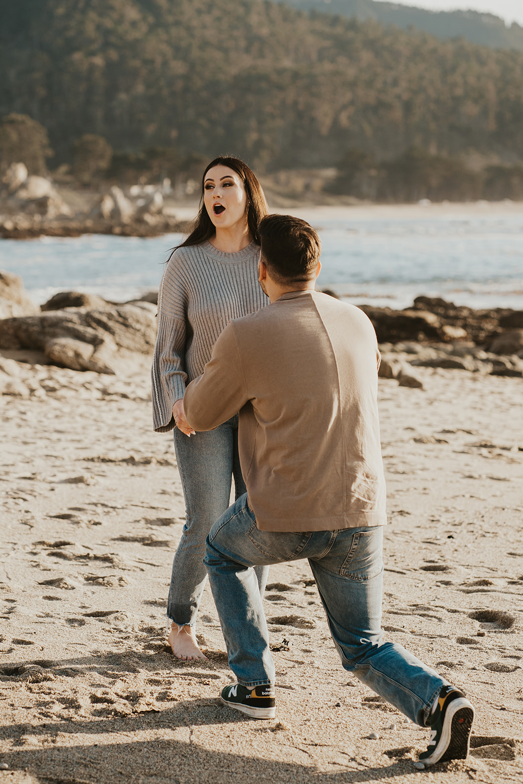 Shocked face as she's proposed to on the beach in Carmel-by-the-Sea