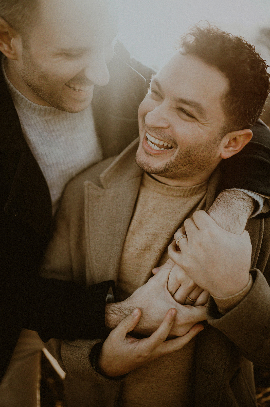 same sex couple laughing for nj engagement session