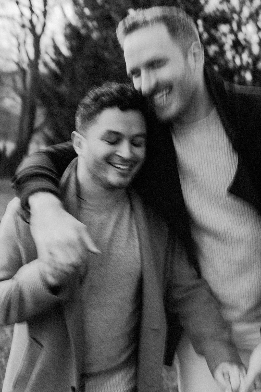 black and white photo of natural moment between gay couple in their nj engagement session 