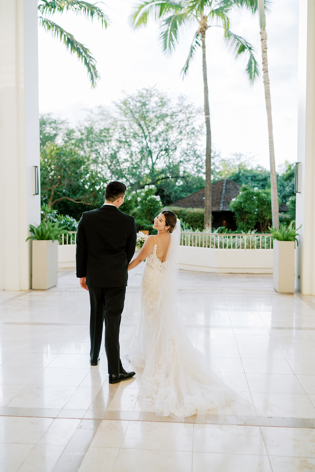 A bride and groom standing in the lobby of The Four Seasons Resort