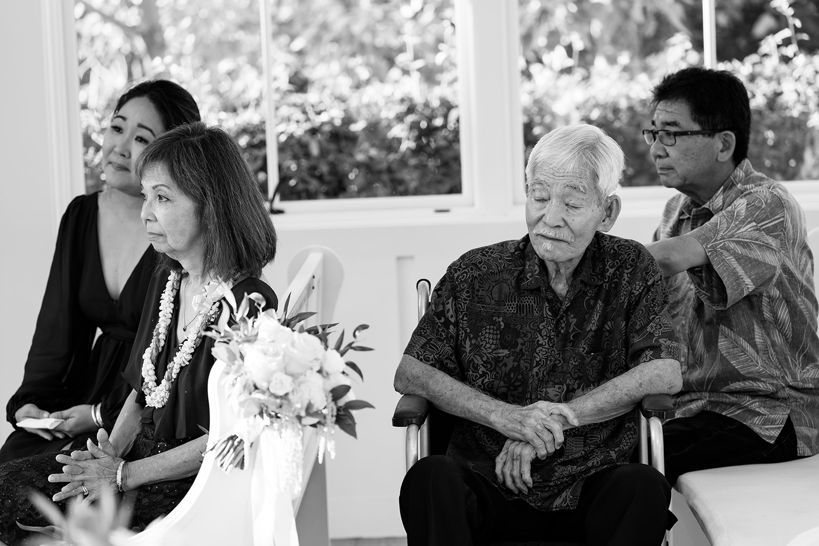 A black and white photo of the bride and groom's parents  taken by Megan Moura Hawaii Wedding Photographer.