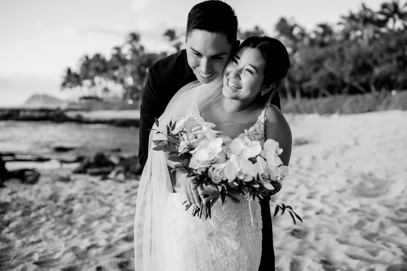 A black and white photo of newlyweds on the Ko'olina beach.