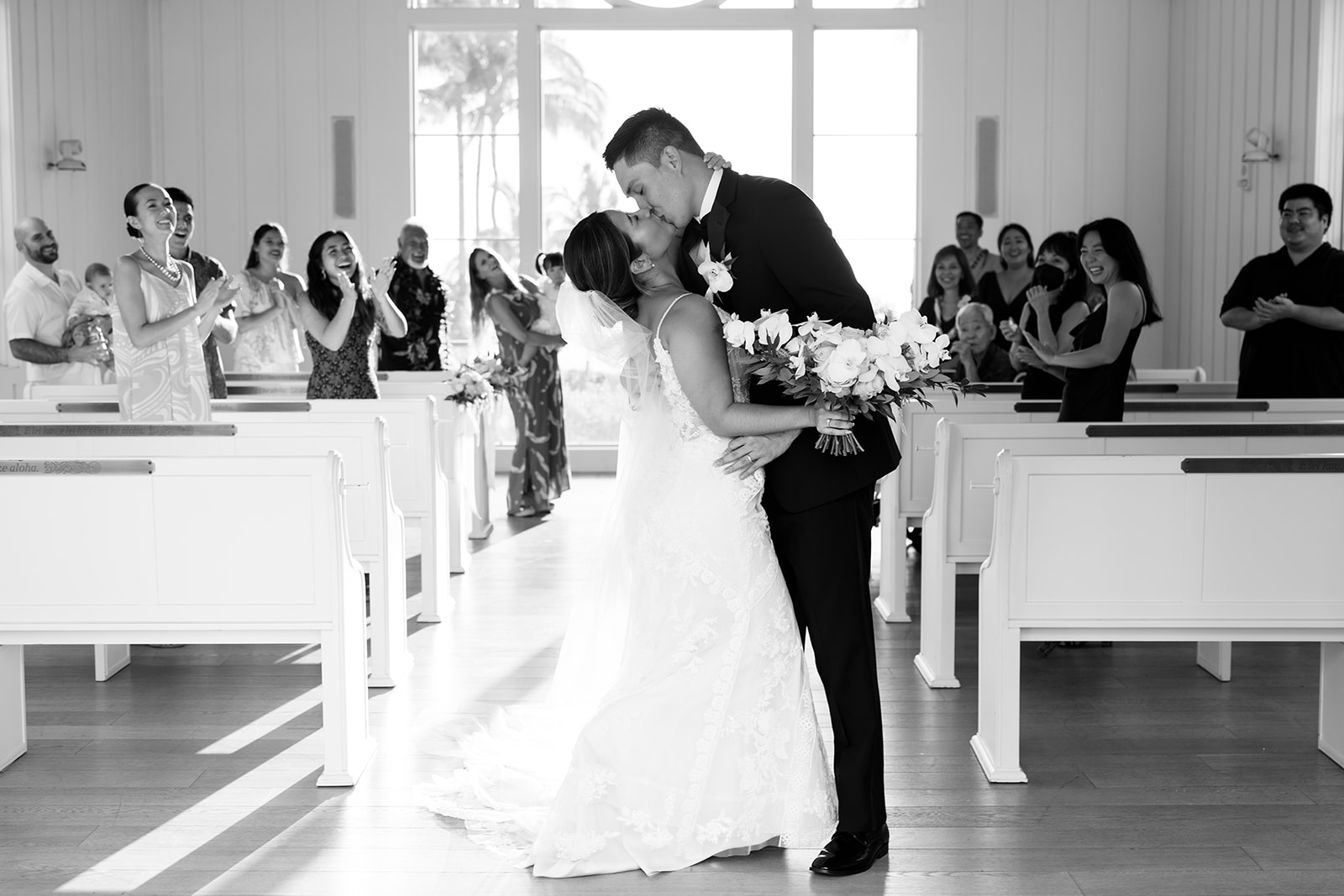 Newlyweds first kissing in a church at the Four Seasons taken by Megan Moura Wedding Photographer