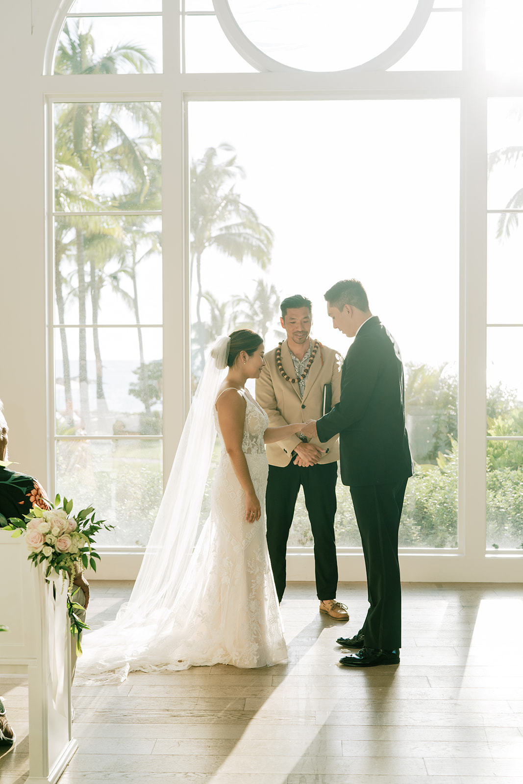Groom putting in the wedding ring to his bride's finger captured by Megan Moura Wedding Photographer