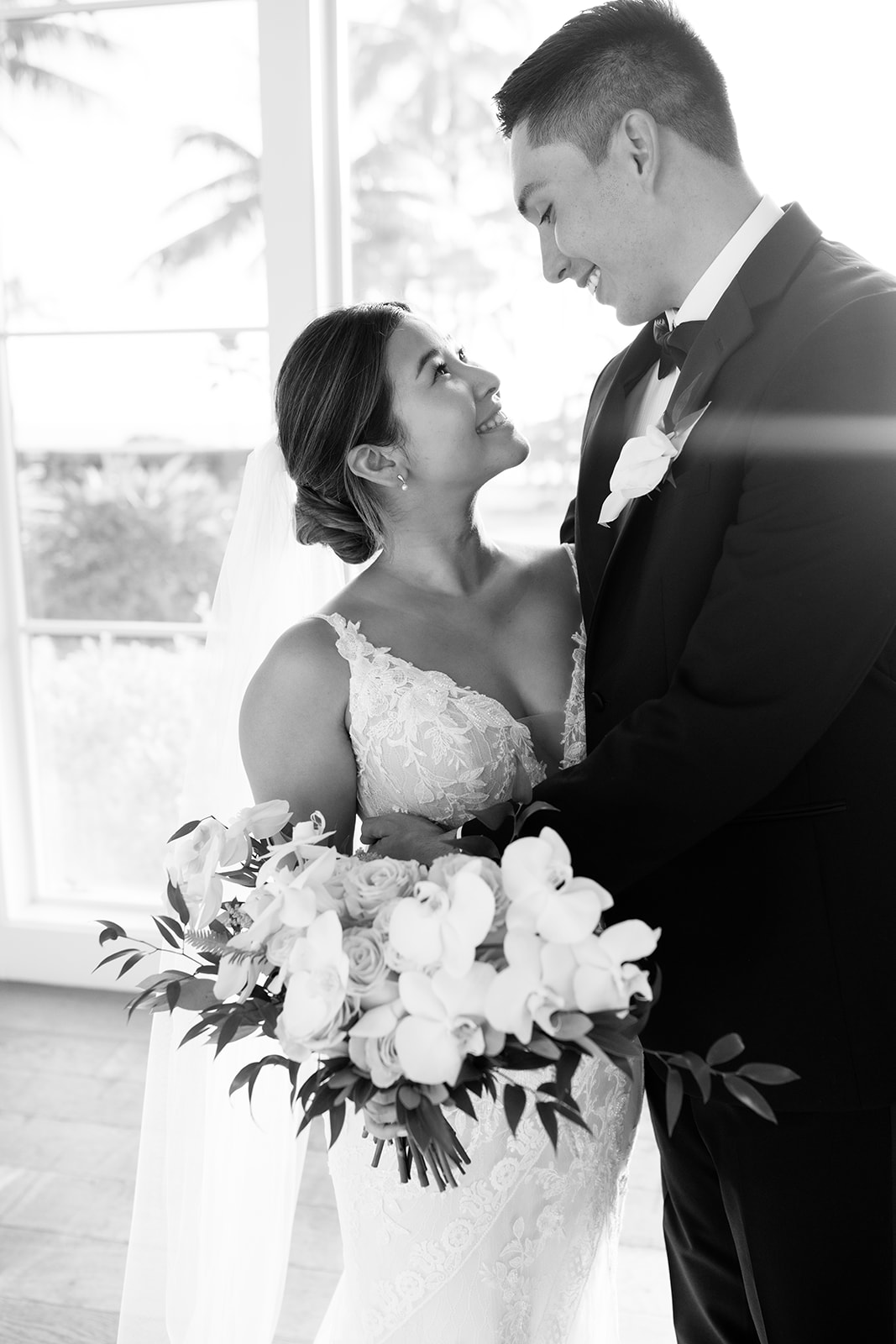 A black and white photo of the newlyweds smiling at each other taken by Megan Moura Wedding Photographer