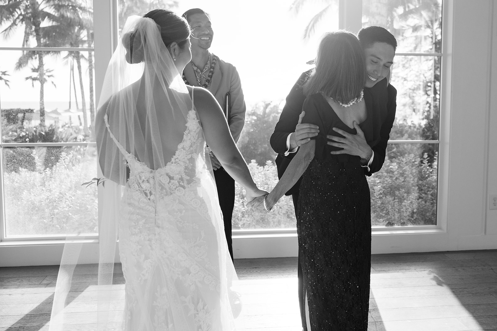Mother of the bride hugging the groom at The Four Seasons Oahu.
