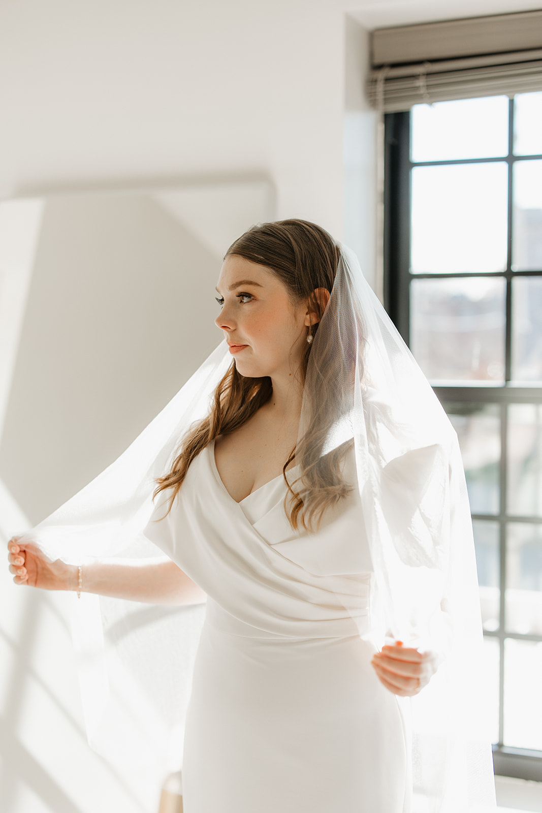 A bride holding her veil at Wild Carrot venue