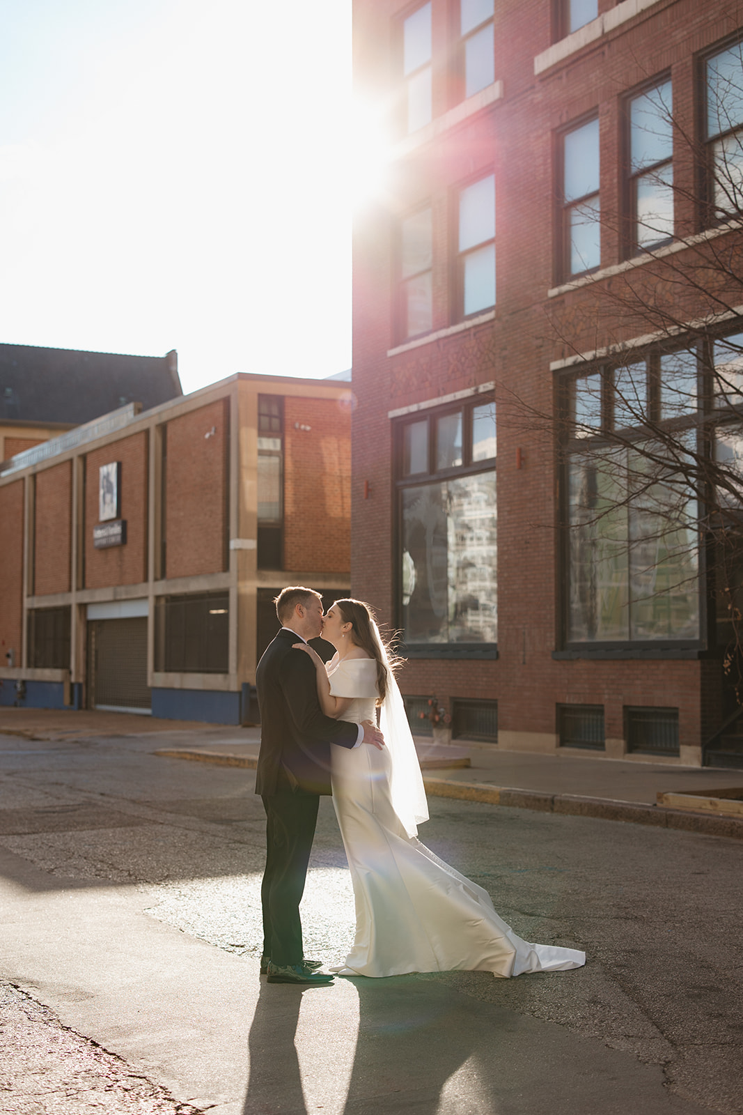 A couple embracing in the street during their St. Louis winter wedding