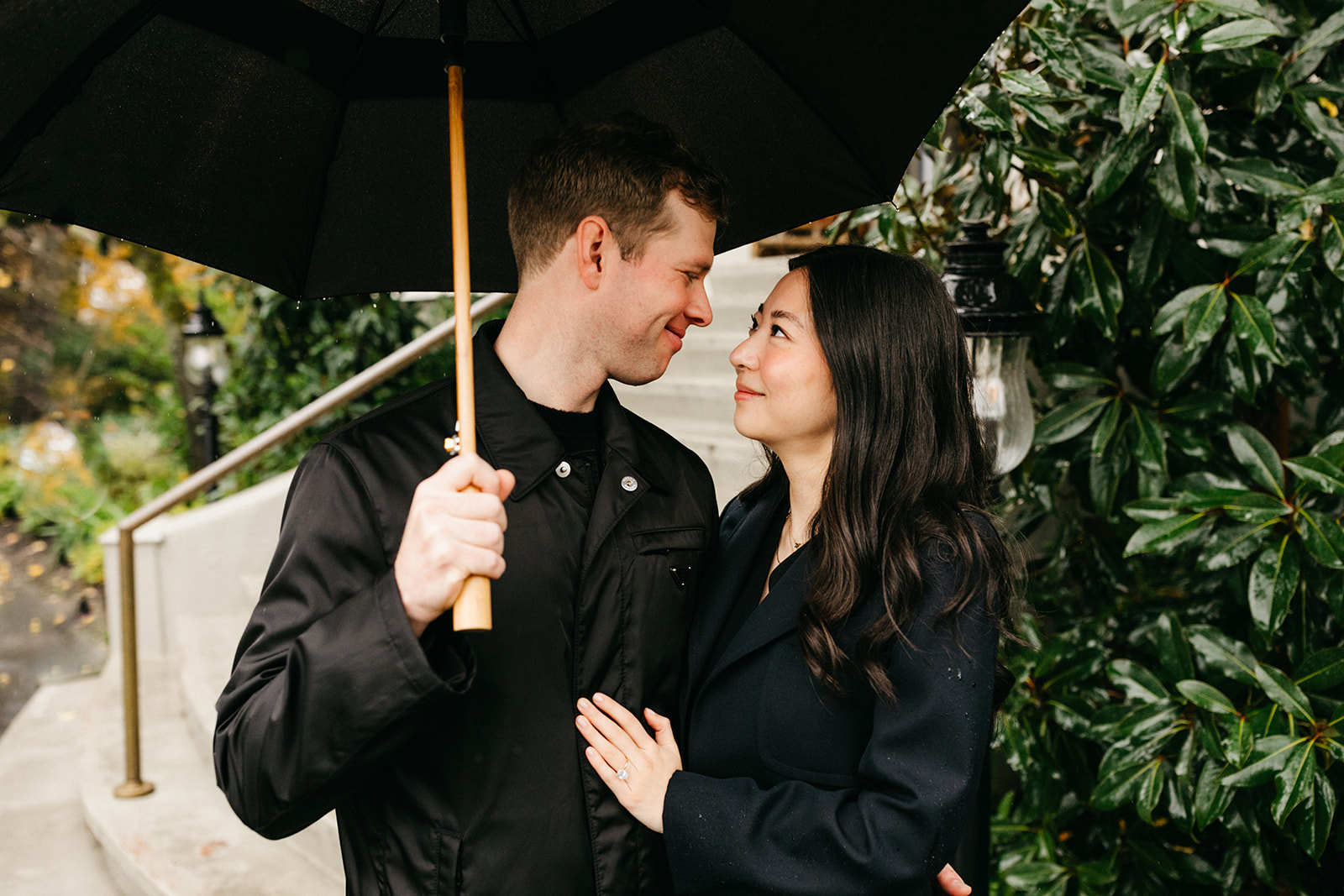 couple standing together under umbrella at the madrona