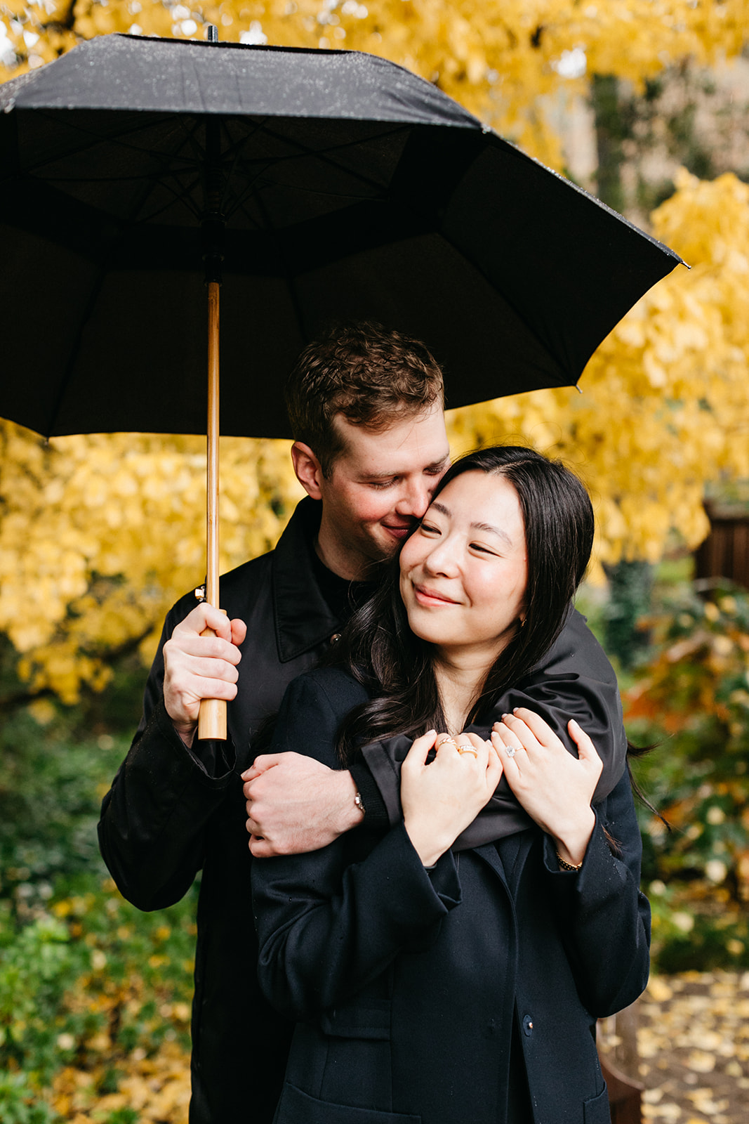 couple standing together under umbrella at the madrona