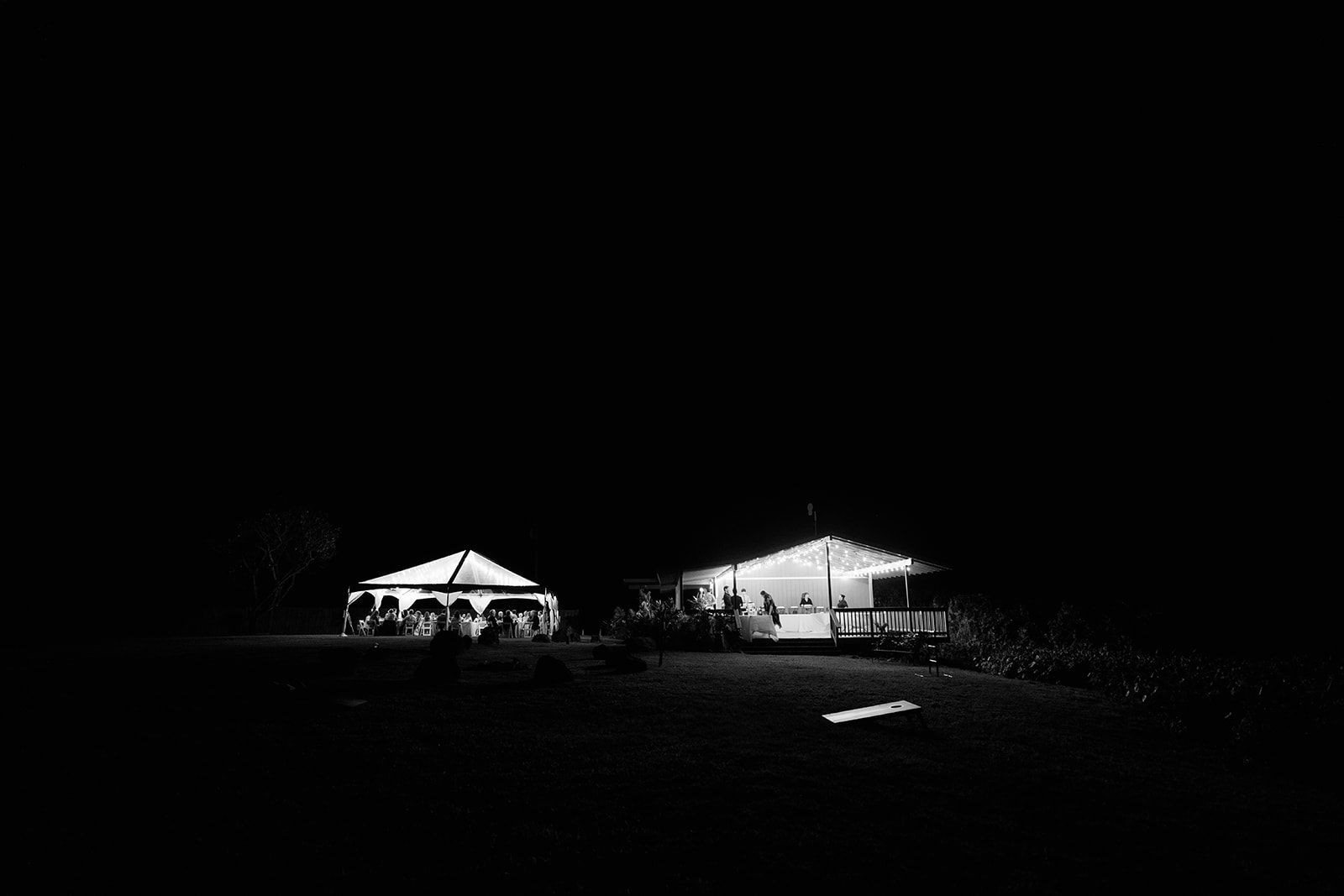 A black and white photo of a tent at night.