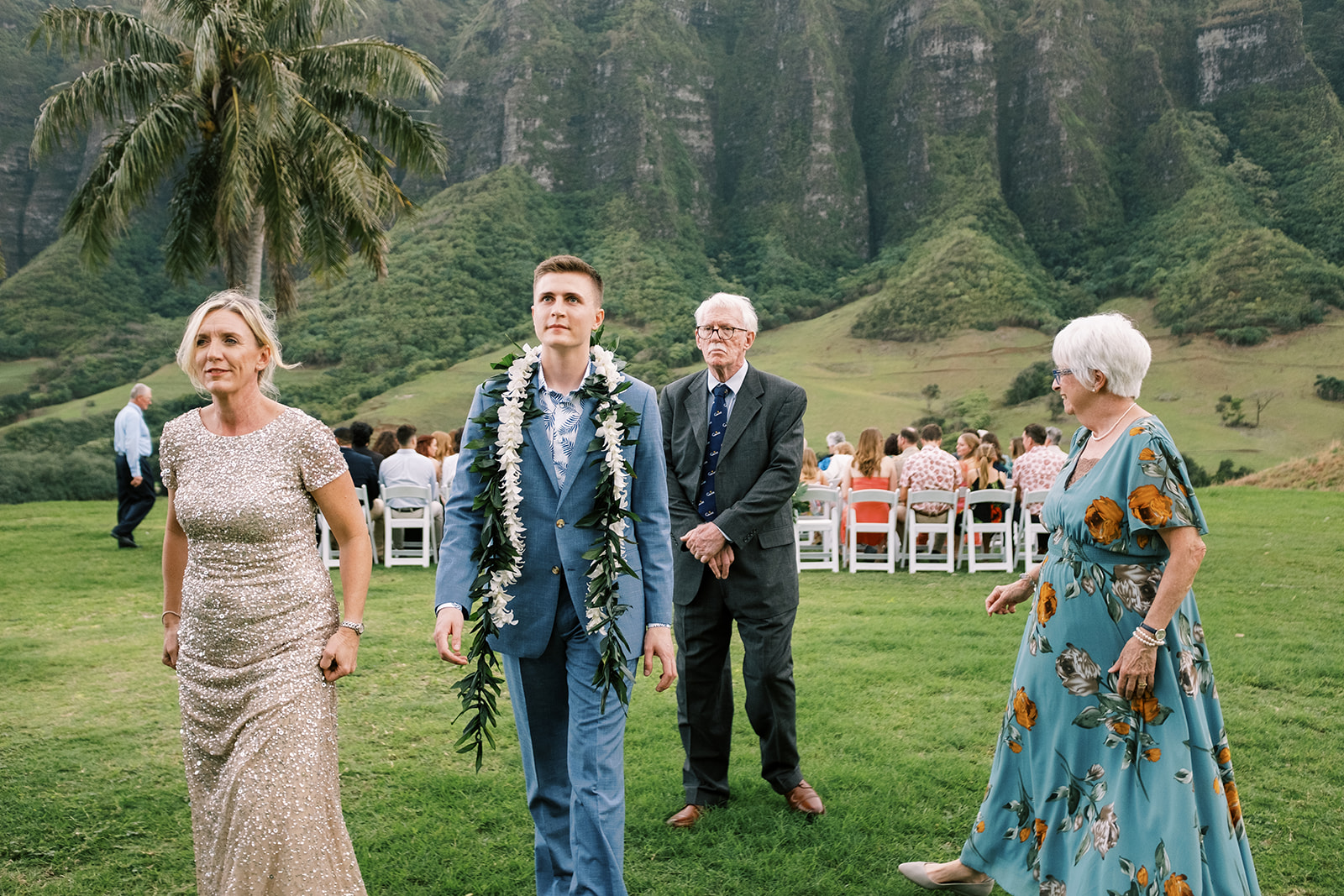 Groom walking down the aisle at a Hawaiian wedding.