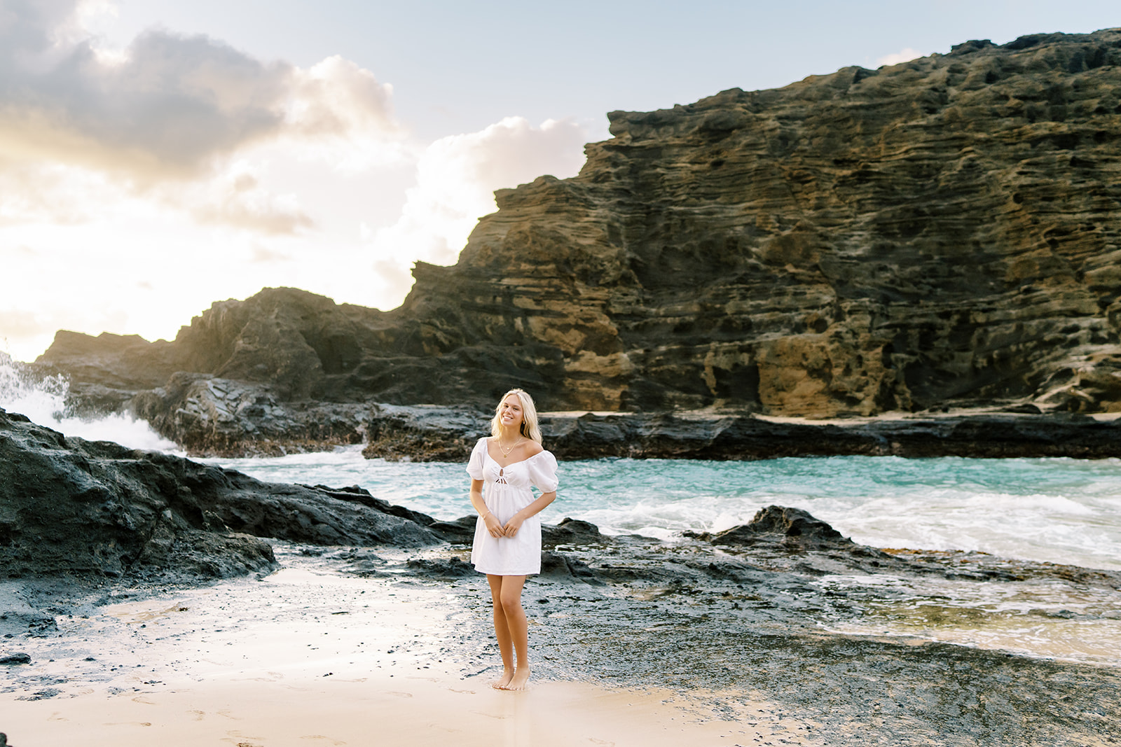 Woman wearing a beautiful white dress at Halona Cove in Oahu Sunrise Portrait Session