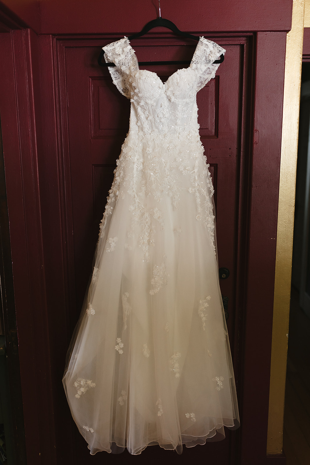 Wedding dress hanging on a doorway