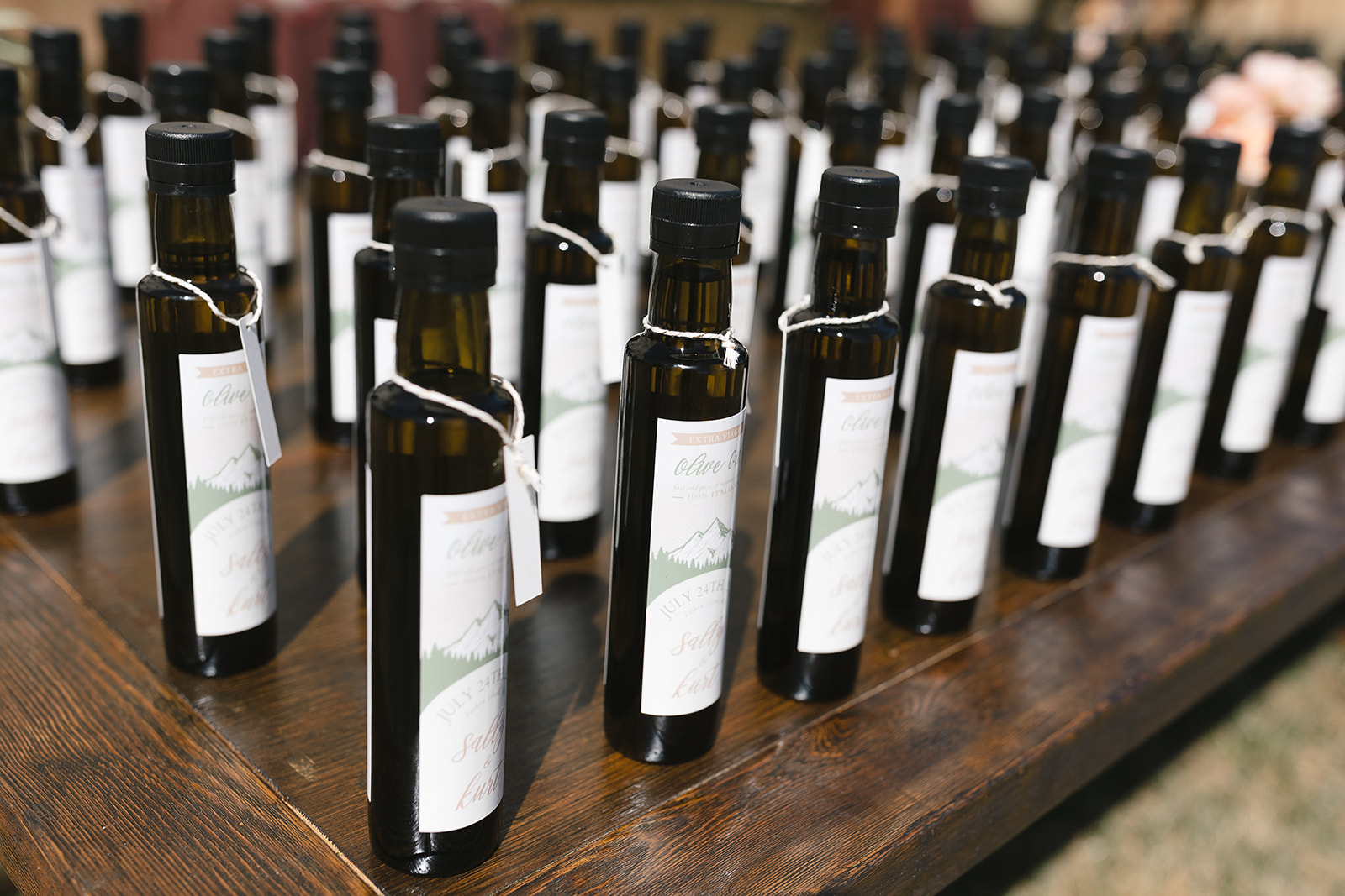 Bottles of homemade olive oil on a table at a wedding on Vashon Island 