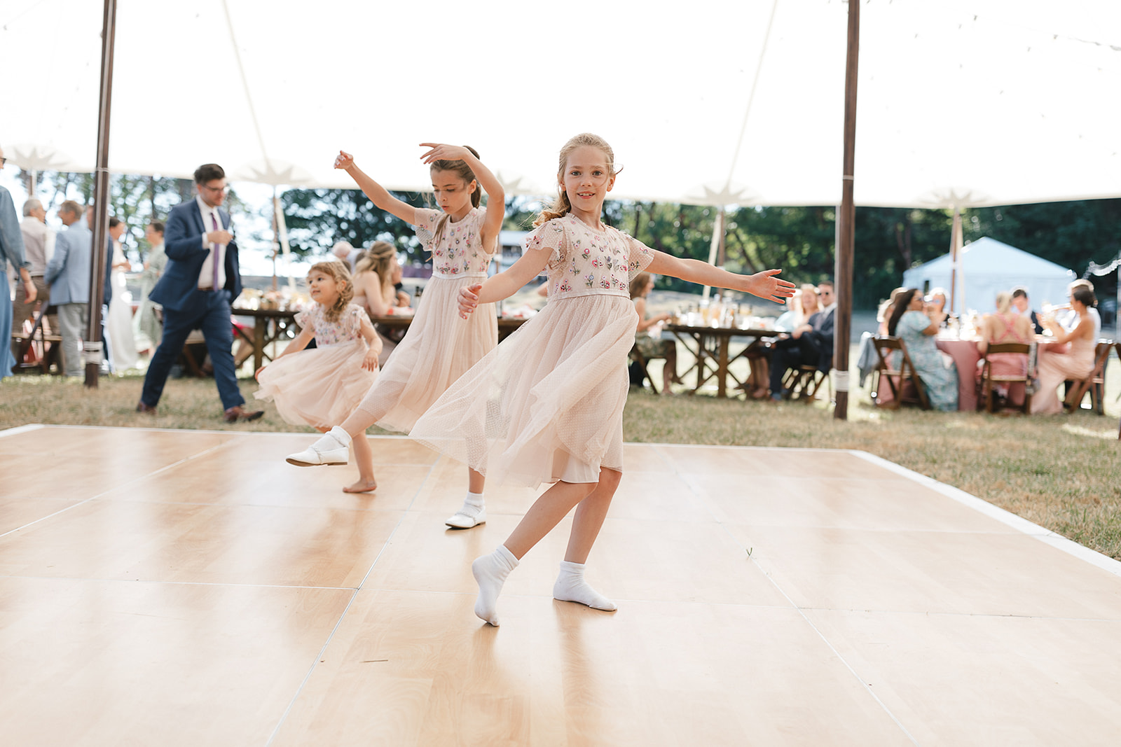 Flower girls dancing on dance floor at a Vashon Island wedding.