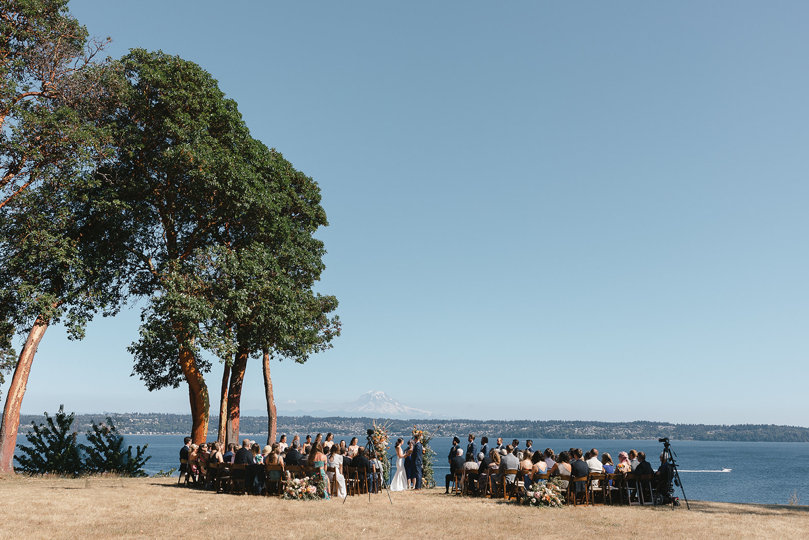 Wide angle view of a Vashon island wedding ceremony with Mount Rainier visible in the distant.