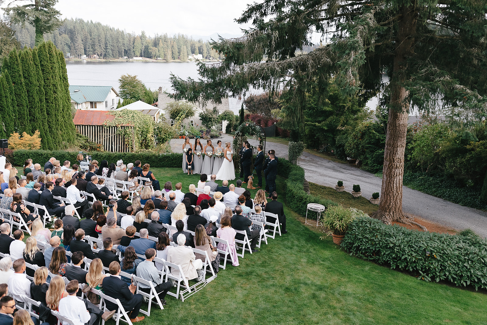 Wide angle view of a wedding ceremony at Green Gates at Flowing Lake in Snohomish.
