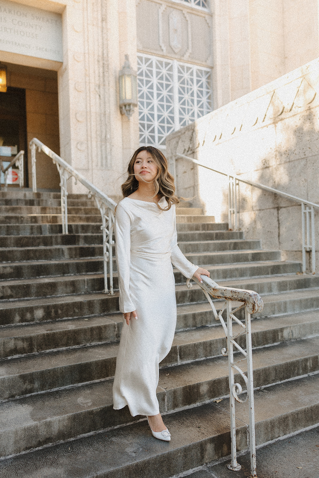 bride standing outside of the courthouse after their elopement in downtown Austin 