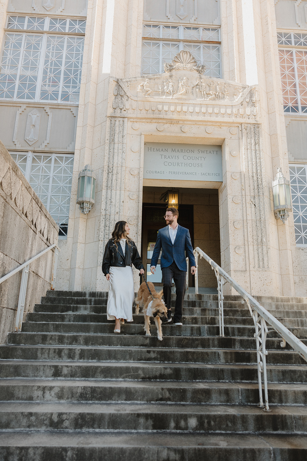 bride and groom outside of courthouse after their elopement in downtown Austin with their dog