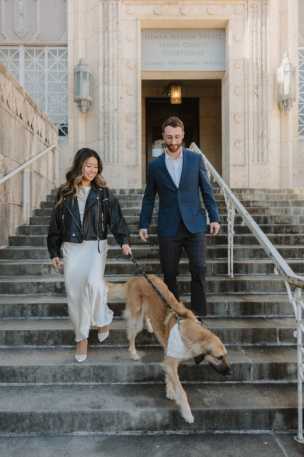 bride and groom outside of courthouse after their elopement in downtown Austin with their dog