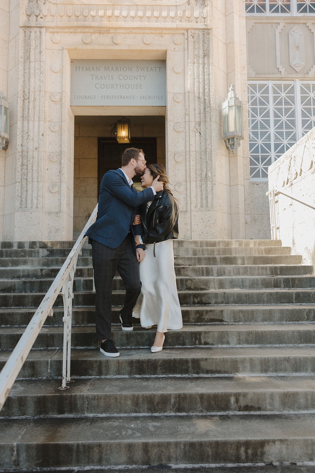 bride and groom walking up the steps of  the courthouse after their elopement in downtown Austin 