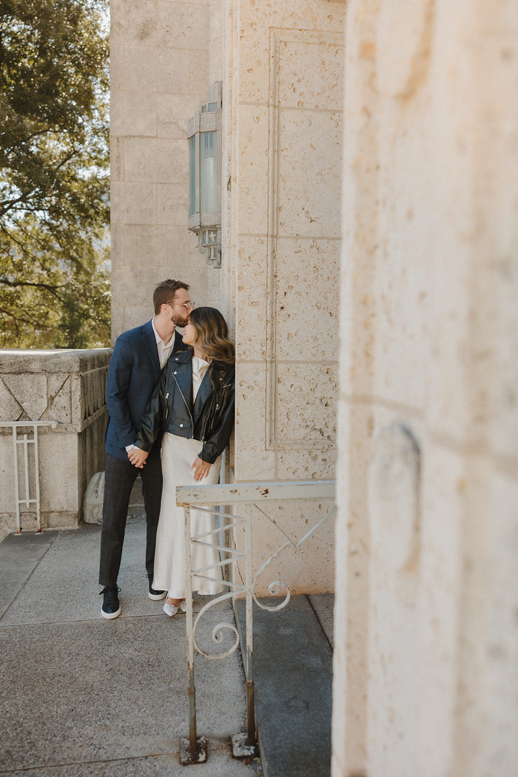 bride and groom kissing outside of the courthouse after their elopement in downtown Austin 