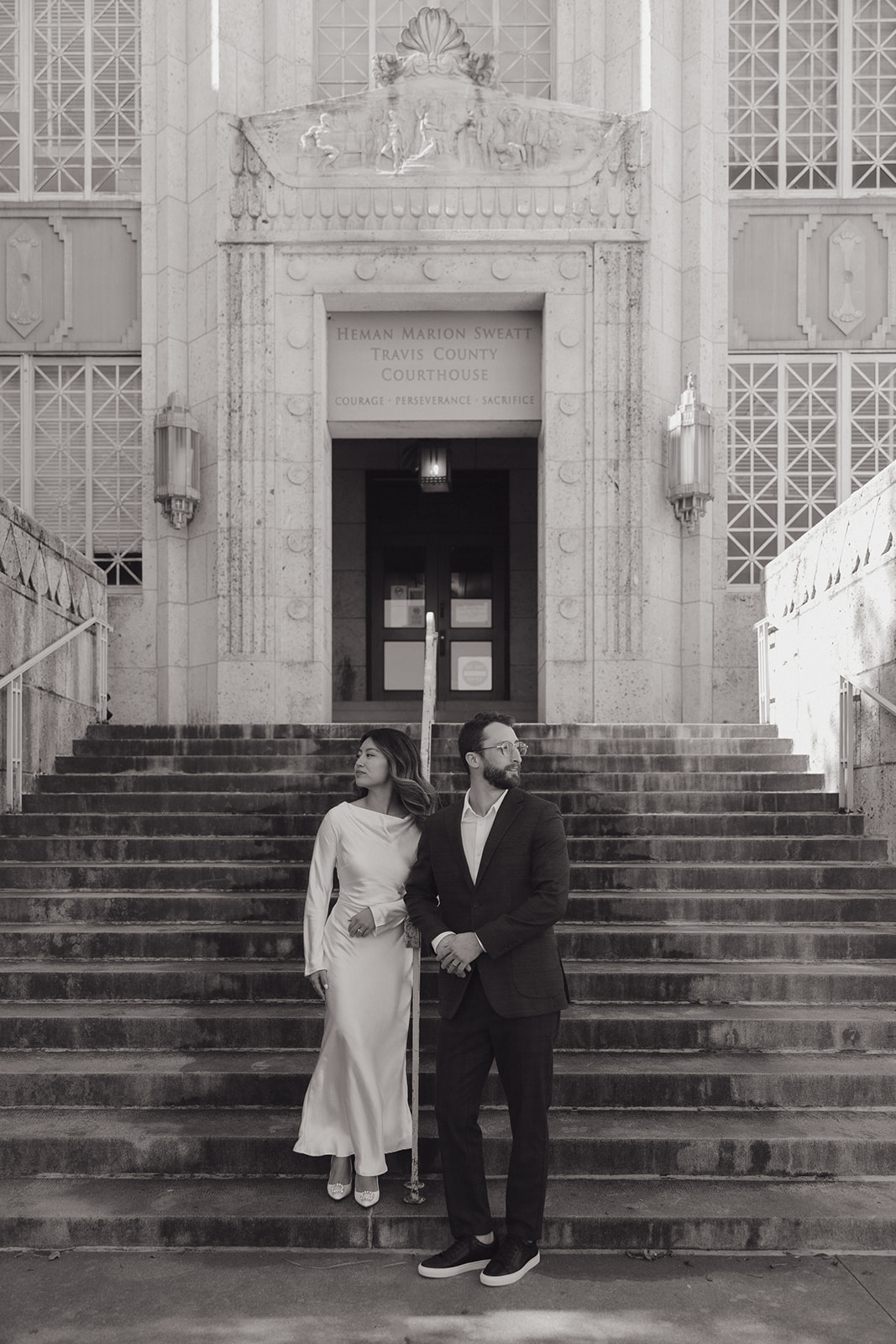 bride and groom standing outside of the courthouse after their elopement in downtown Austin 